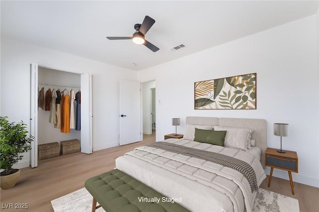 bedroom featuring light wood-style floors, a ceiling fan, and baseboards