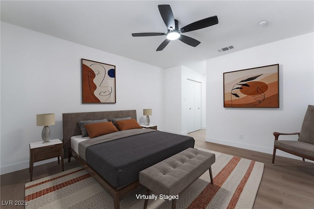 bedroom featuring wood finished floors, baseboards, and ceiling fan