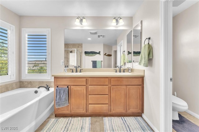 10353 Settlers Run Ave, Las Vegas, NV 89166 - full bathroom with double vanity, a shower stall, a garden tub, and toilet