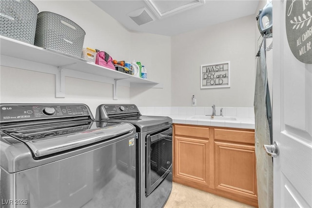 10353 Settlers Run Ave, Las Vegas, NV 89166 - laundry area with independent washer and dryer, attic access, cabinet space, and light tile patterned flooring