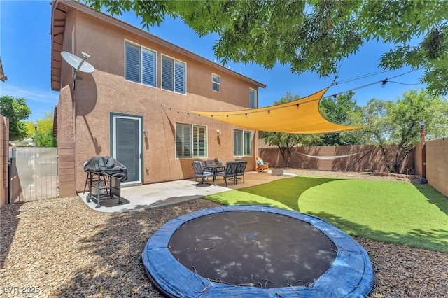 10353 Settlers Run Ave, Las Vegas, NV 89166 - rear view of property with a trampoline, stucco siding, and a patio