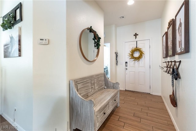mudroom featuring light wood-type flooring and baseboards