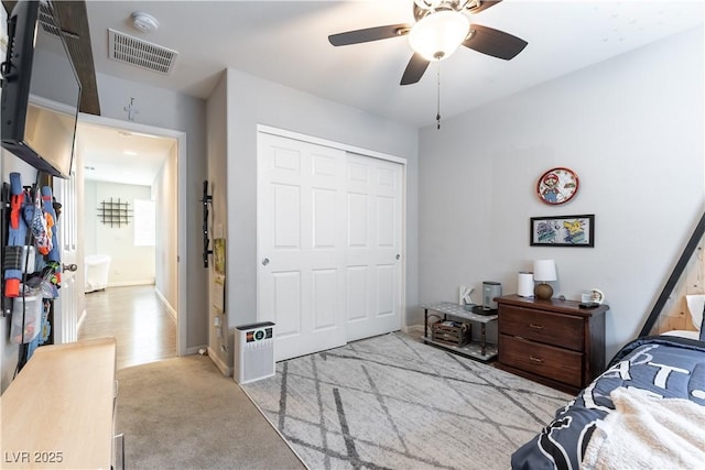 bedroom with a closet, carpet flooring, and ceiling fan