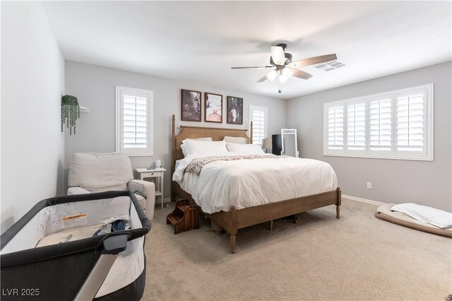 bedroom featuring light carpet, ceiling fan, and baseboards