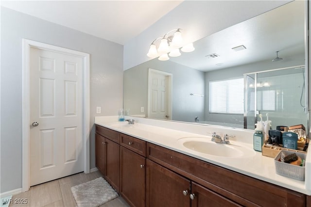 full bathroom featuring a shower stall and double vanity