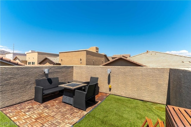 view of patio / terrace with an outdoor fire pit and a fenced backyard