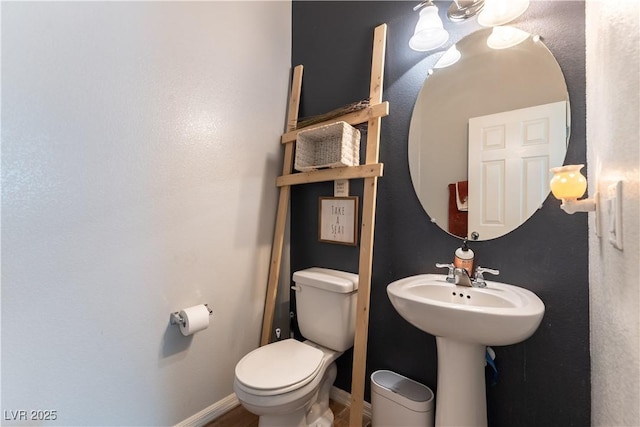 half bathroom featuring toilet