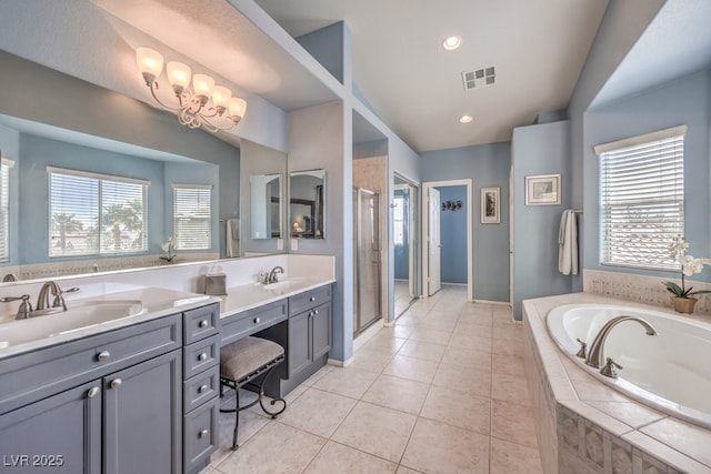 full bathroom featuring plenty of natural light, double vanity, and a bath