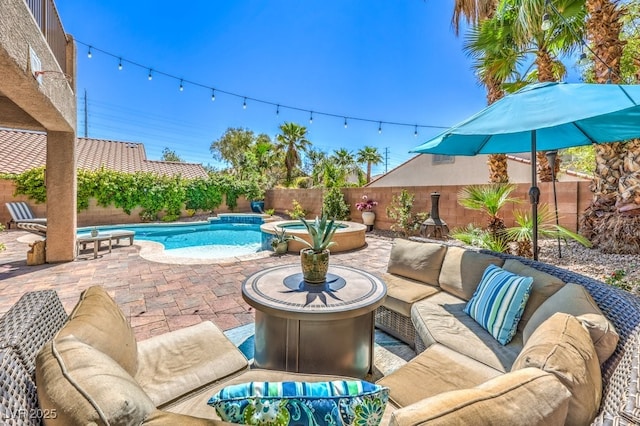 view of pool with an outdoor hangout area, a fenced backyard, a patio, and a pool with connected hot tub