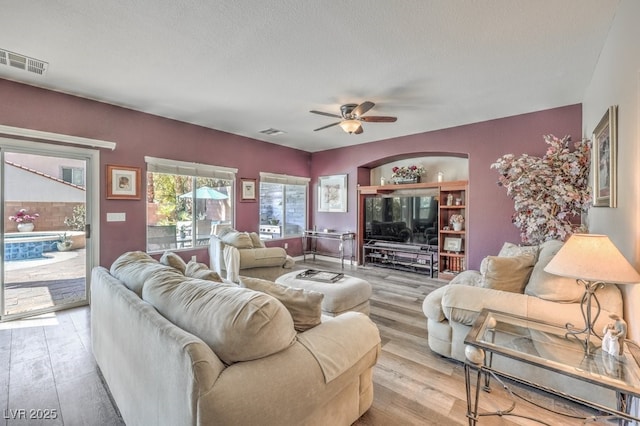 living room featuring ceiling fan and light wood-style floors