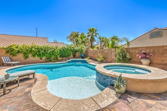 view of swimming pool featuring a fenced backyard and a pool with connected hot tub