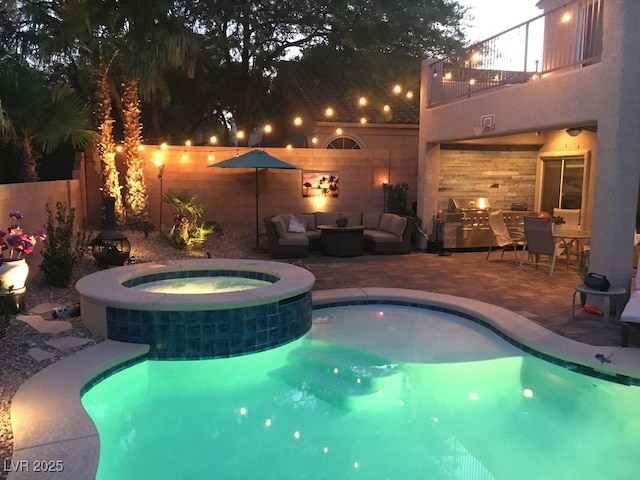 view of swimming pool featuring a patio area, an outdoor hangout area, a pool with connected hot tub, and area for grilling
