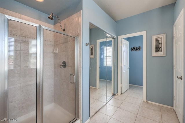 full bathroom featuring a shower stall, tile patterned floors, and baseboards