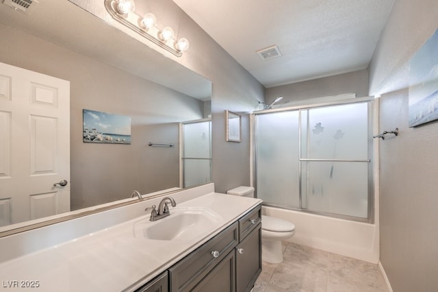full bathroom with vanity, toilet, and shower / bath combination with glass door