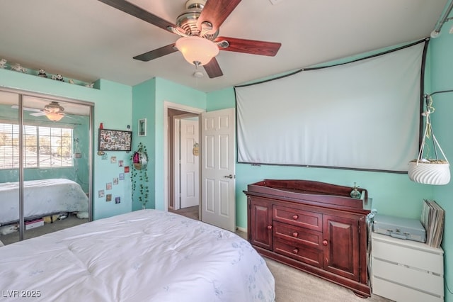 bedroom with light carpet and a ceiling fan