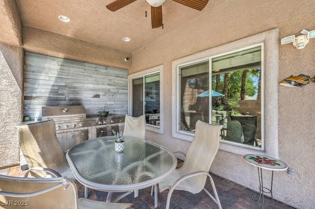view of patio with ceiling fan, outdoor dining space, exterior kitchen, and area for grilling