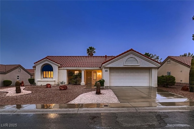 8613 Linderwood Dr, Las Vegas, NV 89134 - view of front of home with a tiled roof, an attached garage, driveway, and stucco siding