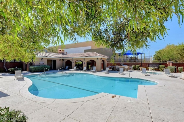 8562 Insignia Ave Unit 102, Las Vegas, NV 89178 - community pool featuring a patio and fence