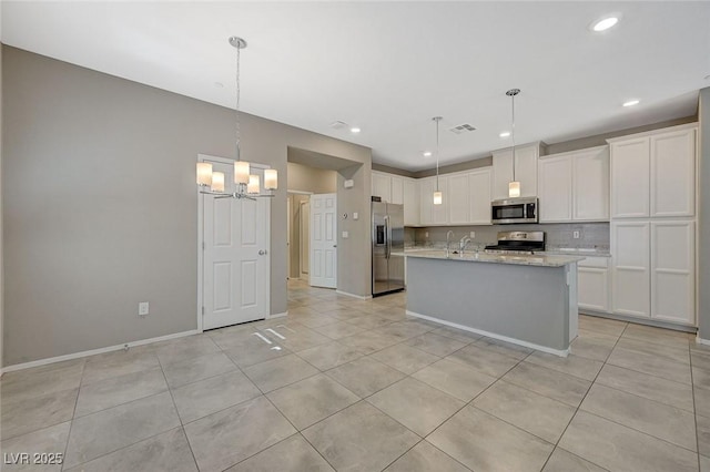8562 Insignia Ave Unit 102, Las Vegas, NV 89178 - kitchen with stainless steel appliances, light tile patterned floors, a chandelier, white cabinetry, and recessed lighting