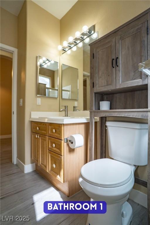 9710 Geiger Peak Ct, Las Vegas, NV 89148 - bathroom with toilet, wood finished floors, baseboards, and vanity