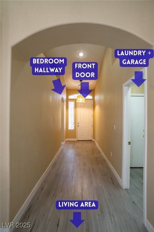 9710 Geiger Peak Ct, Las Vegas, NV 89148 - hallway with wood finished floors, baseboards, and arched walkways