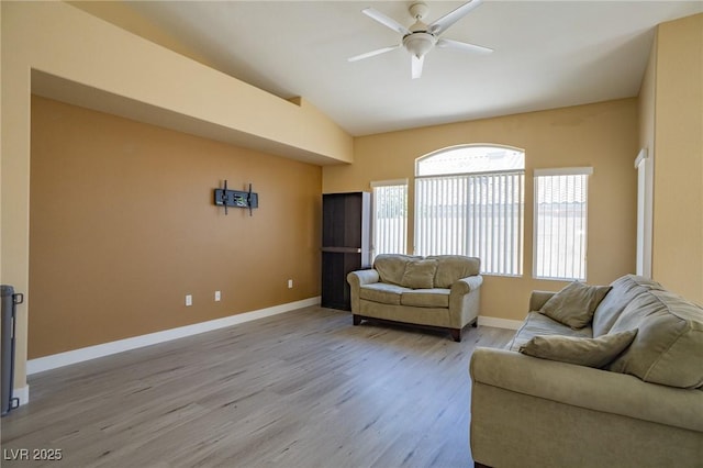 9710 Geiger Peak Ct, Las Vegas, NV 89148 - living room with vaulted ceiling, a ceiling fan, light wood finished floors, and baseboards