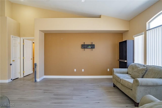 9710 Geiger Peak Ct, Las Vegas, NV 89148 - living area featuring vaulted ceiling, light wood finished floors, and baseboards