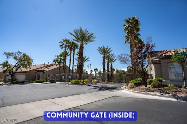 9710 Geiger Peak Ct, Las Vegas, NV 89148 - view of asphalt road with a gate, curbs, and a gated entry
