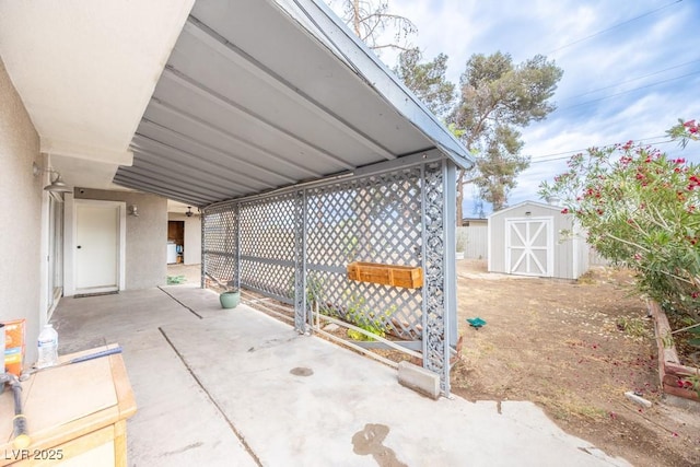 view of patio featuring a storage unit and an outbuilding
