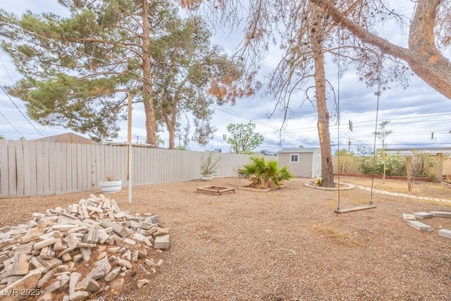 fenced backyard featuring an outbuilding and a storage unit