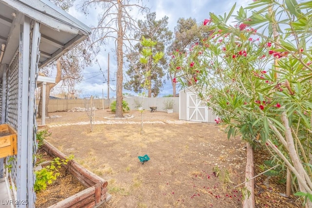 fenced backyard featuring a storage shed and an outdoor structure