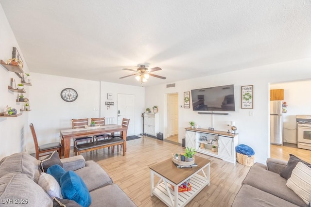 living area featuring ceiling fan and light wood-style floors