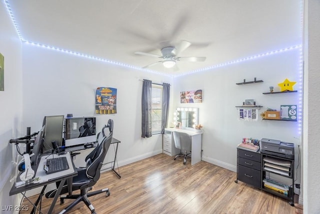 office featuring ceiling fan, light wood-style flooring, and baseboards