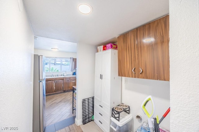 hallway featuring a sink