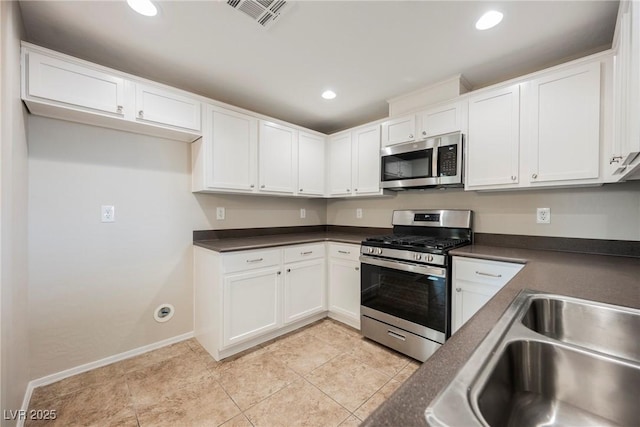 6868 Sky Pointe Dr Unit 1112, Las Vegas, NV 89131 - kitchen featuring appliances with stainless steel finishes, dark countertops, white cabinets, and recessed lighting