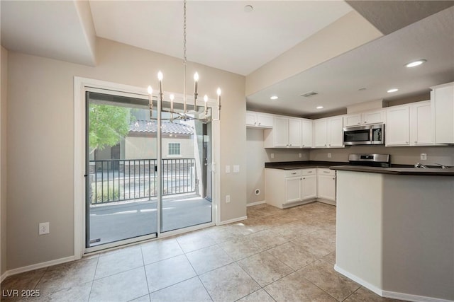 6868 Sky Pointe Dr Unit 1112, Las Vegas, NV 89131 - kitchen with stainless steel appliances, a chandelier, dark countertops, baseboards, and recessed lighting