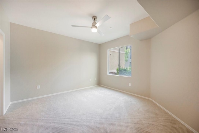 6868 Sky Pointe Dr Unit 1112, Las Vegas, NV 89131 - unfurnished room featuring light colored carpet, ceiling fan, and baseboards