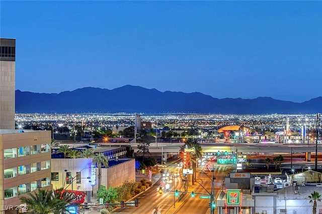 view of mountain backdrop featuring a view of city lights