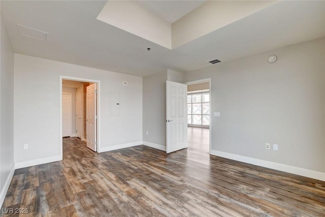 unfurnished room featuring wood finished floors and baseboards