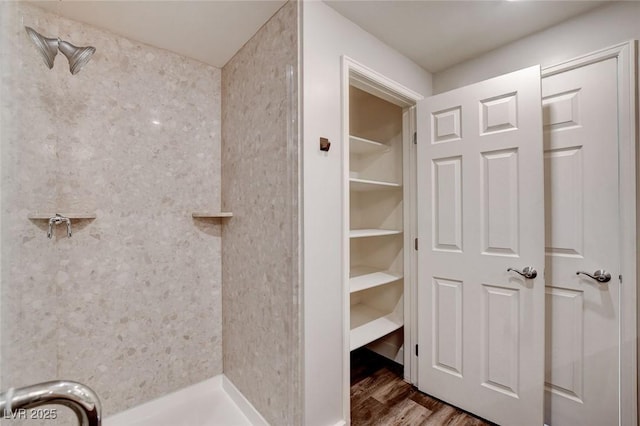 full bath featuring wood finished floors and a shower