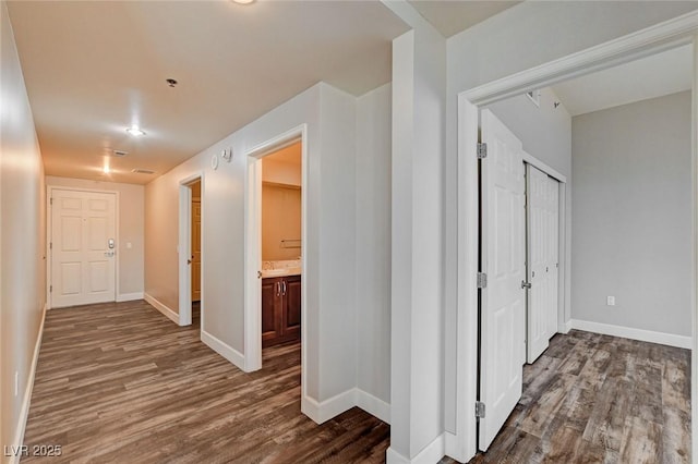hall featuring wood finished floors and baseboards