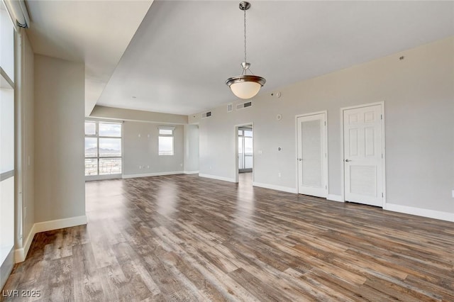 unfurnished room with wood finished floors and baseboards