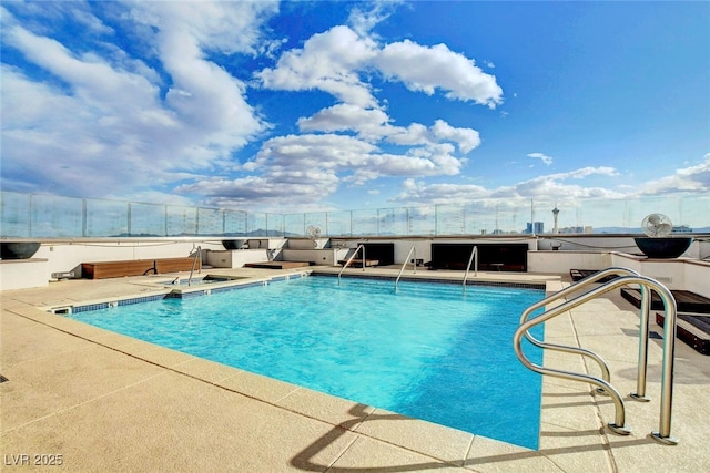 view of pool featuring fence and a patio