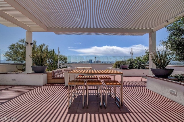 view of patio / terrace with a pergola and outdoor dining space