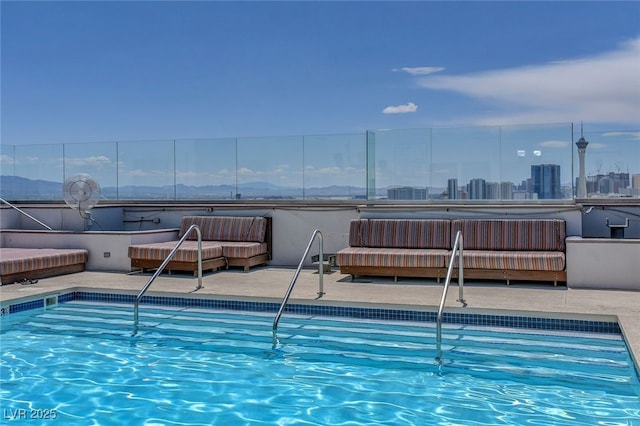 community pool with outdoor lounge area and a patio
