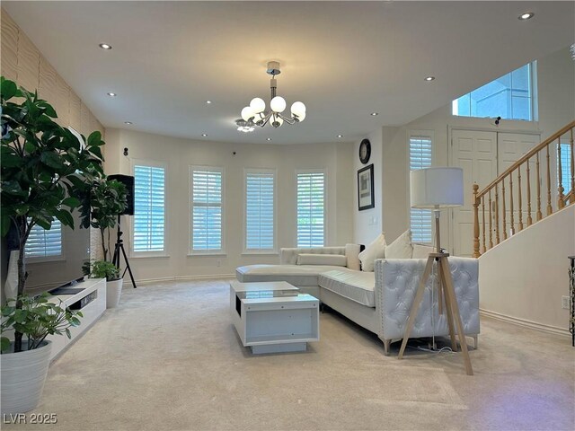 2451 Tour Edition Dr, Henderson, NV 89074 - living room with light colored carpet, recessed lighting, healthy amount of natural light, a chandelier, and baseboards