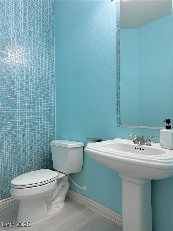 2451 Tour Edition Dr, Henderson, NV 89074 - half bathroom featuring toilet, a sink, and baseboards
