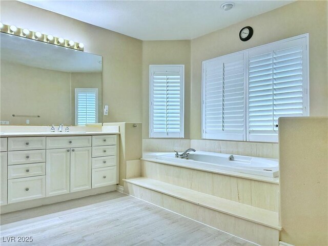 2451 Tour Edition Dr, Henderson, NV 89074 - full bathroom featuring a bath, wood finished floors, and vanity