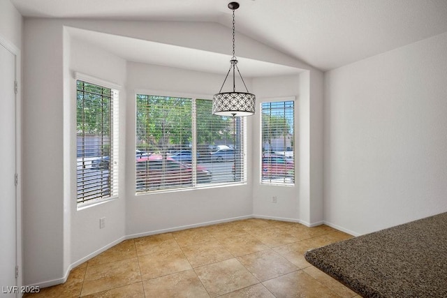 7755 Pacific Rim Ct, Las Vegas, NV 89139 - unfurnished dining area with plenty of natural light, vaulted ceiling, tile patterned flooring, and baseboards