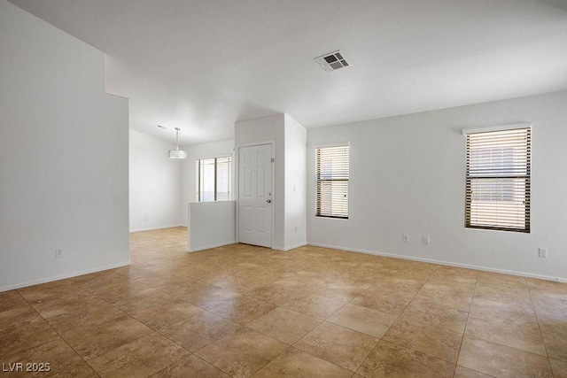 7755 Pacific Rim Ct, Las Vegas, NV 89139 - empty room with vaulted ceiling, baseboards, and light tile patterned flooring